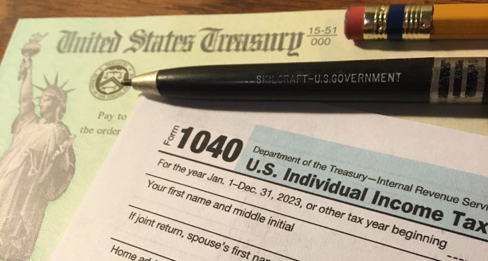 A 1040 form and tax return check