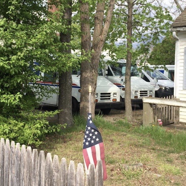 American Flag and Postal Trucks